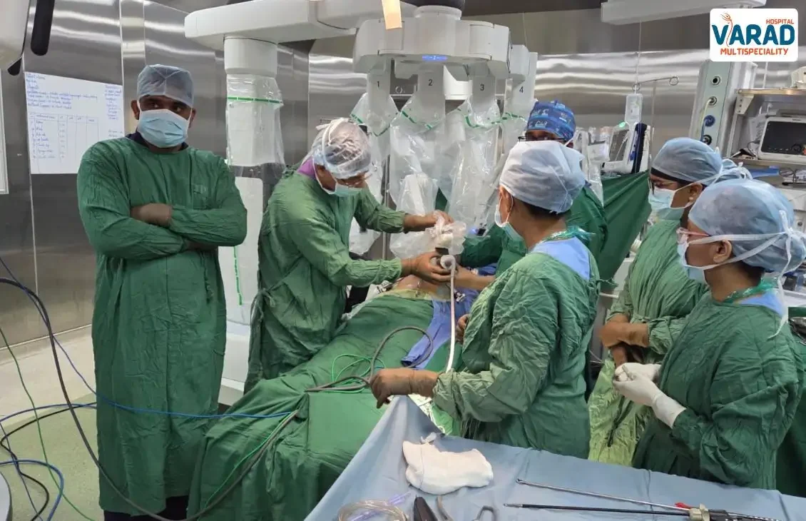 Dr. Vinayak Doing Setup of Robotic Cholecystectomy Surgery in Pune with other staff around him.